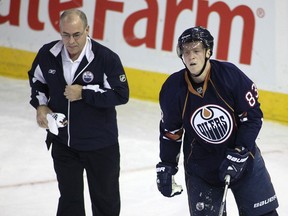 Ken Lowe helps Oilers forward Ales Hemsky off the ice during a game against the L.A. Kings at Rexall Place in November 2009. Postmedia File