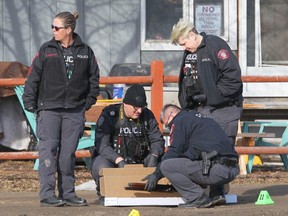 Police remove a shotgun in the street in 2700 blk of 86 Ave SE in Calgary on Saturday, March 23, 2019 following a police involved shooting early Saturday morning.Jim Wells/Postmedia