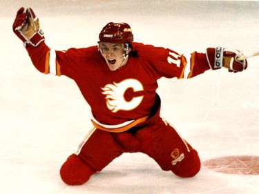 Battle of Alberta NHL playoffs. The Edmonton Oilers vs the Calgary Flames April 14, 1991.   Calgary Flames Theoren Fleury celebrates as he slides across the ice after scoring against Edmonton Oilers goalie #31 Grant Fuhr in overtime during game 6 on April, 14, 1991, at Northlands Coliseum in Edmonton. The series was won in game 7 by the Oilers in overtime in Calgary.  Perry Mah/EDMONTON SUN