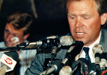 Aug. 9, 1988. Edmonton Oilers President, General Manager and Head Coach Glen Sather talks to the media as Ex-Edmonton Oilers superstar Wayne Gretzky wipes a tear in the background during the press conference at Molson House in Edmonton Alta., on Aug. 9, 1988. It was announced that Gretzky was traded (and sold) to the LA Kings by team owner Peter Pocklington. Perry Mah/Edmonton Sun