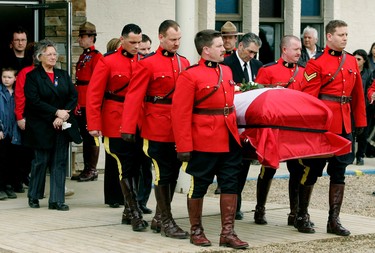 Lac La Biche, Alta  March 11, 2005. Grace Johnston, mother of slain Royal Canadian Mounted Police officer Leo Johnston, follows her son's casket after funeral services in Lac La Biche, Alta. on Friday March 11, 2005. Johnston was one of four RCMP officers killed at a farm near Mayerthorpe. Perry Mah/Edmonton Sun