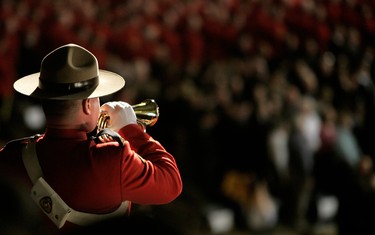 Bugler Cst. Owen Rusticus of "E" Division plays during a memorial ceremony at the U of A Butterdome in Edmonton, Alta. on March 10, 2005 in honour of four RCMP officers shot and killed by James Roszko on his farm near Mayerthorpe. Perry Mah/Edmonton Sun