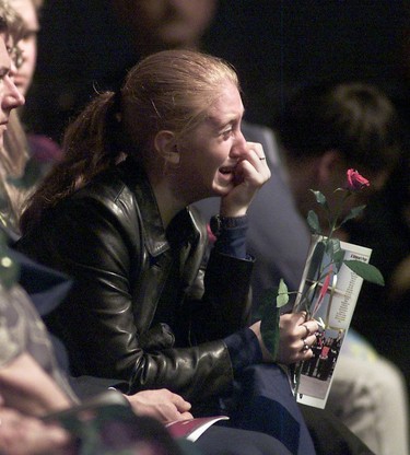 Miranda Boutilier, the fiancé of Richard Green, clutches a rose and sobs in grief as a tribute to Private Smith is read during the Memorial Service at Skyreach Centre  in Edmonton on April 28, 2002. Four Canadian soldiers were killed April 17, 2002 by a US laser-guided bomb that landed on Canadian forces during a training exercise. Eight Canadian soldiers were wounded. EDMONTON SUN