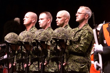 Members of the PPCLI Regiment carry out the helmets and rifles of the fallen soldiers after memorial services at Skyreach Centre  in Edmonton on April 28, 2002. Four Canadian soldiers were killed April 17, 2002 by a US laser-guided bomb that landed on Canadian forces during a training exercise. Eight Canadian soldiers were wounded.   PERRY MAH/EDMONTON SUN