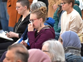 A woman wipes a tear at a solidarity gathering at city hall on Monday, March 18, 2019, mourning the Christchurch, New Zealand, mass shooting victims and others and Canada's response to the alt-right militia groups, in Edmonton.