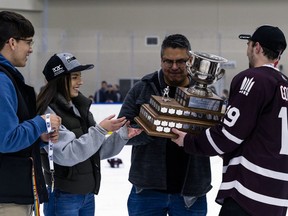 MacEwan University Griffins captain Cam Gotaas presents the championship trophy to the family of Nakehko Lamothe on Saturday March 23, 2019 at the Downtown Community Arena. Nakehko Lamothe died earlier this season collapsing after a game in Calgary.