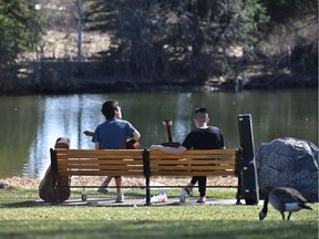 Guitar nirvana for musicians Michael Wang (L) and David Chang, what better way to spend the afternoon with temperatures over 20º at Hawrelak Park in Edmonton, May 4, 2017. Ed Kaiser/Postmedia (Standalone Photo)