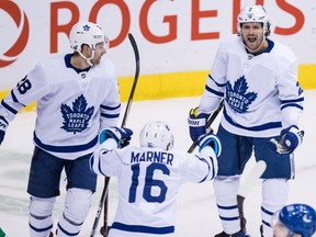 Toronto Maple Leafs' Ron Hainsey, back right, Connor Brown, back left, and Mitchell Marner celebrate Hainsey's goal during second period NHL hockey action against the Vancouver Canucks, in Vancouver on Wednesday, March 6, 2019.