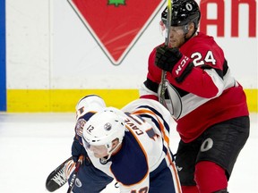 Ottawa Senators left wing Oscar Lindberg (24) collides with Edmonton Oilers centre Colby Cave during third period NHL action in Ottawa, Thursday, Feb. 28, 2019. The Oilers defeated the Senators 4-2.