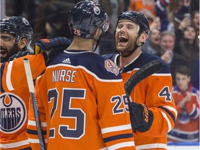 Edmonton Oilers Zack Kassian (44), Darnell Nurse (25), Jujhar Khaira (16) and Leon Draisaitl (29) celebrate their win over the New York Rangers during overtime NHL hockey action in Edmonton, Alta., on Monday March 11, 2019. The Oilers won 3-2.