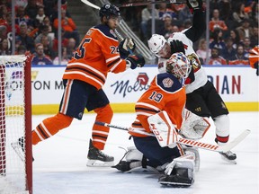 Ottawa Senators' Bobby Ryan, centre, is high-sticked by Edmonton Oilers' Darnell Nurse, left, as goalie Mikko Koskinen follows the play during first period NHL hockey action in Edmonton, Saturday, March 23, 2019.