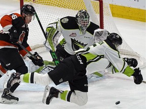 Edmonton Oil Kings Scott Atkinson (right) is checked by Medicine Hat Tigers Corson Hopwo in front of Oil Kings goalie Dylan Myskiw during WHL hockey game action at Rogers Place on Friday March 1, 2019.