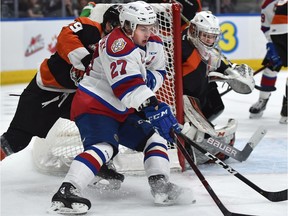 Edmonton Oil Kings Trey Fix-Wolansky (27) getting hounded by Medicine Hat Tigers Ryan Chyzowski (29) during WHL first round playoff action at Rogers Place in Edmonton, March 29, 2019.