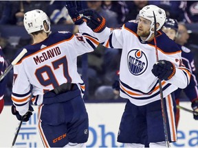 Edmonton Oilers forward Leon Draisaitl, right, of Germany, celebrates his goal against the Columbus Blue Jackets with teammate forward Connor McDavid during the second period of an NHL hockey game in Columbus, Ohio, Saturday, March 2, 2019.