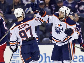 Edmonton Oilers forward Leon Draisaitl, right, celebrates his goal against the Columbus Blue Jackets with teammate Connor McDavid during the second period of an NHL hockey game in Columbus, Ohio, Saturday, March 2, 2019.
