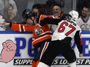 Edmonton Oilers Alex Chiasson (left) and Ottawa Senators Ben Harpur rough each other up during first period NHL game action in Edmonton on Saturday March 23, 2019.