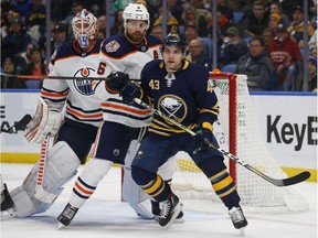 Buffalo Sabres forward Conor Sheary (43) and Edmonton Oilers defenseman Adam Larsson (6) battle for position during the third period of an NHL hockey game, Monday, March 4, 2019, in Buffalo N.Y.
