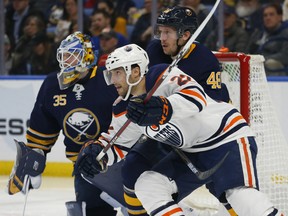 Buffalo Sabres defenseman Matt Hunwick (48) and Edmonton Oilers forward Tobias Rieder (22) battle for position during the second period of an NHL hockey game, Monday, March. 4, 2019, in Buffalo N.Y.