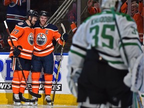 Edmonton Oilers Connor McDavid (97) celebrates his goal with Oscar Klefbom (77) scored on Dallas Stars goalie Anton Khudobin (35) during NHL action at Rogers Place in Edmonton, March 28, 2019. Ed Kaiser/Postmedia