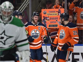 Edmonton Oilers Connor McDavid (97) celebrates his goal with Leon Draisaitl (29) on Dallas Stars goalie Anton Khudobin (35) during NHL action at Rogers Place in Edmonton, March 28, 2019.