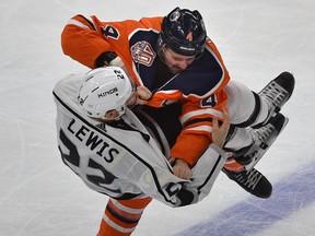 Edmonton Oilers Kris Russell (4) takes down Los Angeles Kings Trevor Lewis (22) in a fight during NHL action at Rogers Place in Edmonton, March 26, 2019.