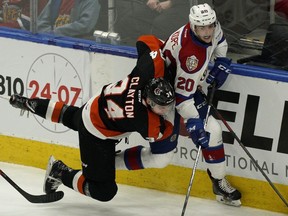 Edmonton Oil Kings David Kope (right) is checked by Medicine Hat Tigers Cole Clayton during first period WHL playoff game action in Edmonton on Saturday March 23, 2019.