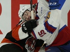 Edmonton Oil Kings Scott Atkinson (right) is checked by Medicine Hat Tigers Nick McCarry during first period WHL playoff game action in Edmonton on Saturday March 23, 2019. The Oil Kings won Game 2, 4-3 on Sunday.