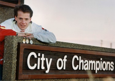 Oct. 7,1990. Royal Glenora Club trained skater Kurt Browning poses with his three gold medals that he has won at the World Figure Skating Championships at the City of Champions sign that greets people entering Edmonton on QEII on the south end of town. Perry Mah/Edmonton Sun/Postmedia Network