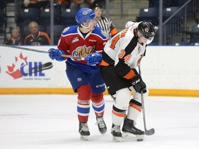 Medicine Hat Tigers defenceman Cole Clayton protects the puck from Edmonton Oil Kings winger Josh Williams during Game 4 of the Western Hockey League's Eastern Conference quarter-final on Wednesday, March, 27, 2019 at the Canalta Centre.
