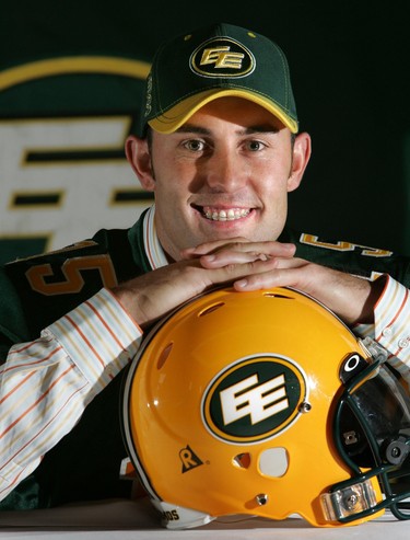 Edmonton AB:  MAY 16, 2005 :   Quarterback Ricky Ray puts on an Edmonton Eskimos' jersey at a press conference at Edmonton Petroleum Club to announce Ray's new contract with the team.     Photo by Perry Mah/Edmonton Sun