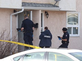 An Edmonton police forensic team investigates a suspicious death outside a home in the Lakewood Village neighbourhood on Saturday, March 23, 2019.