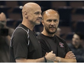 Then-Canadian volleyball coach Glenn Hoag talks to assistant Terry Danyluk during practice on June 19, 2014, in Edmonton.