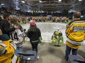 Family members and friends light candles during the Humboldt Broncos memorial service at Elgar Petersen Arena in Humboldt, SK on Saturday, April 6, 2019.