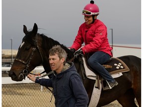 Jockey Shannon Beauregard is led out to the track by trainer Ron Grieves on April 28 at Century Mile Racetrack near Edmonton, on Thursday, April 18, 2019.