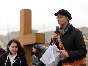 Linda Winski speaks during the 39th Annual Good Friday Outdoor Way of the Cross in Edmonton, on Friday. The Way of the Cross is a long-running Easter tradition in the city.