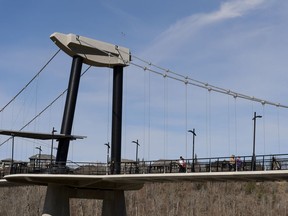 Cyclists, walkers and runners cross the Fort Edmonton Footbridge on a warm day in Edmonton, on Sunday, April 21, 2019.