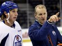 Edmonton Oilers head coach Ralph Kruger gives instructions to Ryan Smith in a training camp file photo at Rexall Place in Edmonton on January 17, 2013.