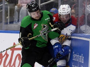 The Edmonton Oil Kings' Trey Fix-Wolansky (27) is checked by the Prince Albert Raiders' Brayden Pachal (8) during Game 3 WHL Eastern Conference Championship first period action at Rogers Place, in Edmonton Tuesday April 23, 2019.