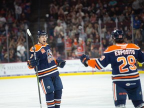 Evan Bouchard of the Bakersfield Condors celebrates a goal with Luke Esposito.