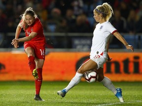 Janine Beckie of Canada shoots past Rachel Daly of England during the International Friendly between England Women and Canada Women at The Academy Stadium on April 05, 2019 in Manchester, England. Beckie scored in a 2-1 win against Nigeria on Monday in Murcia, Spain.