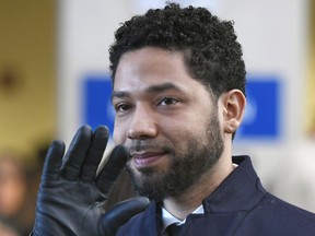 In this March 26, 2019, file photo, actor Jussie Smollett smiles and waves to supporters before leaving Cook County Court after his charges were dropped in Chicago.