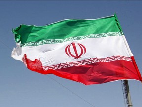 The Iranian flag flutters.