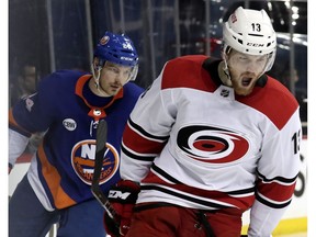 Carolina Hurricanes left wing Warren Foegele, front, reacts after scoring a goal against the New York Islanders during the third period of Game 2 of an NHL hockey second-round playoff series, Sunday, April 28, 2019, in New York. Islanders defenseman Scott Mayfield, left, follows Foegele.