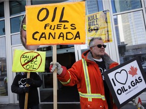 Oil and gas supporters picket outside the National Energy Board, during the release of the board's reconsideration report on marine shipping related to the Trans Mountain expansion project, in Calgary, Alta., Friday, Feb. 22, 2019.THE CANADIAN PRESS/Jeff McIntosh ORG XMIT: JMC113