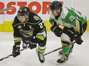 Edmonton Oil Kings captain Trey Fix-Wolansky (left) is checked by Prince Albert Raiders Sean Montgomery during third period WHL hockey game action in Edmonton on Wednesday November 28, 2018.