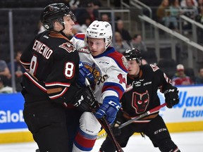 Edmonton Oil Kings Carter Souch (44) runs into Calgary Hitmen Vladislav Yeryomenko (8) trying to deflect the puck during WHL second round playoff action at Rogers Place in Edmonton, April 6, 2019.