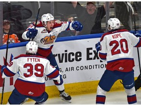 Edmonton Oil Kings Jake Neighbours (21) celebrates scoring the winning goal in overtime with David Kope (20) and Andrew Fyten (39) to defeat the Calgary Hitmen during WHL second round playoff action at Rogers Place in Edmonton on April 6, 2019.