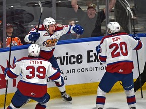 Edmonton Oil Kings Jake Neighbours (21) celebrates scoring the winning goal in overtime with David Kope (20) and Andrew Fyten (39) to defeat the Calgary Hitmen during WHL second round playoff action at Rogers Place in Edmonton, April 6, 2019.