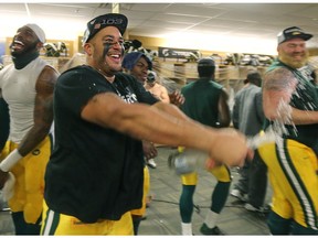 Edmonton Eskimos defensive tackle Eddie Steele sprays champagne  in the locker-room after defeating the Ottawa Redblacks in the 2015 Grey Cup at Investors Group Field in Winnipeg on Nov. 29, 2015.