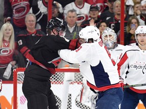 Alex Ovechkinof the Washington Capitals knocks out Carolina Hurricanes' Andrei Svechnikov (left) as they fight during the first period in Game 3 their first-round series. (GETTY IMAGES)